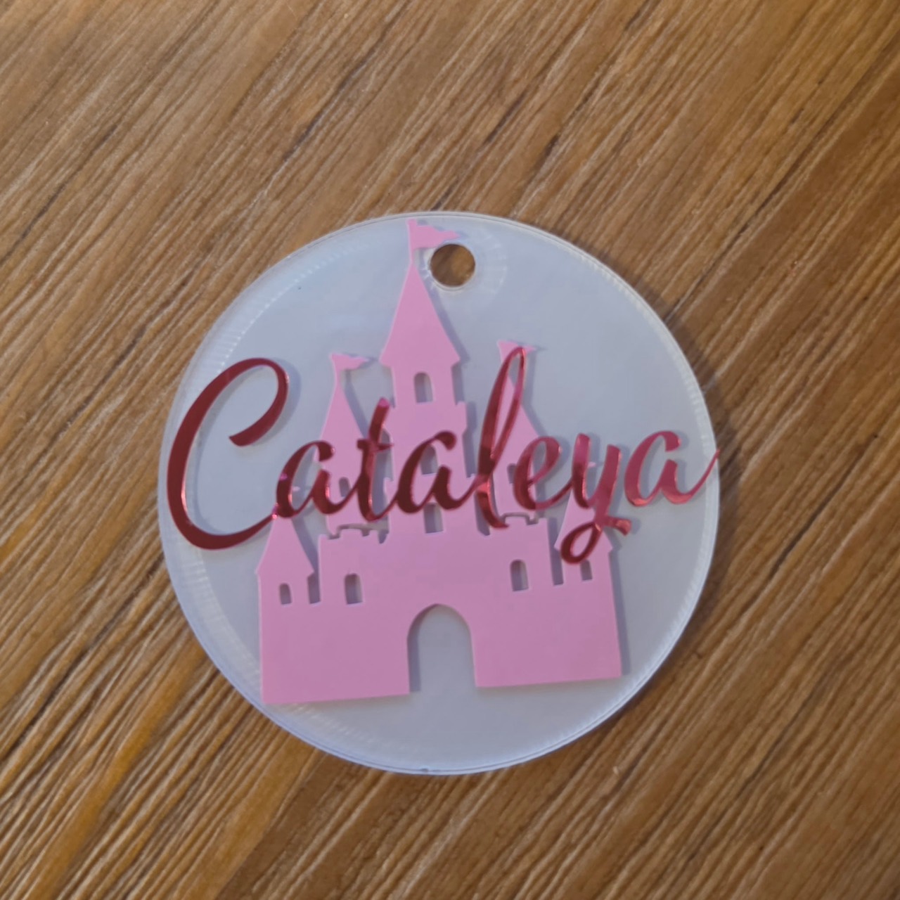 Round pink castle name tag personalized with Cataleya